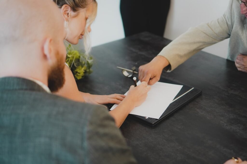 People reviewing and signing legal documents for a property partition